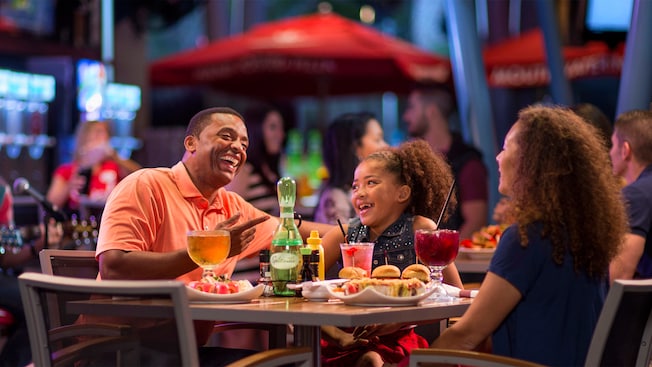 A father and his young daughter enjoy food and beverages at the Splitsville Dining Room
