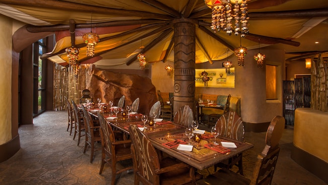 Mushroom-like canopy over a row of tables in brown tribal-themed dining room