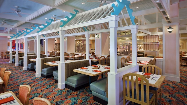 Bright and airy dining room with blue booths and birch wood tables and chairs