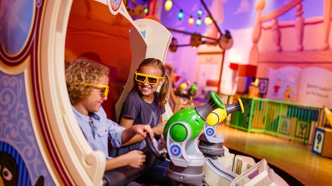 Kids in 3D glasses on the Toy Story Mania! attraction at Disneyâs Hollywood Studios