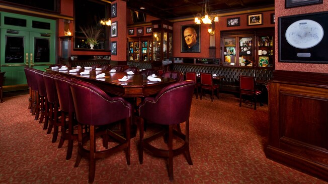 Mahogany leather-upholstered chairs and a long table in an alternate dining room