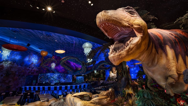 A 15-foot T-Rex shows its sharp teeth and a giant octopus lurks in the background