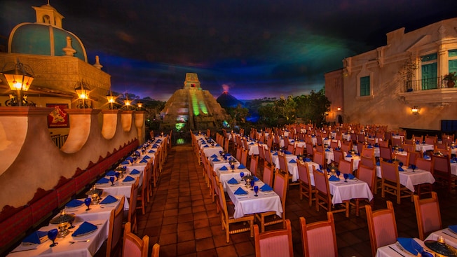 Dimly lit dining area with Mayan pyramid in background