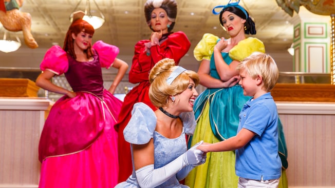 Cinderella welcomes a boy while her evil stepmother and 2 sisters look on