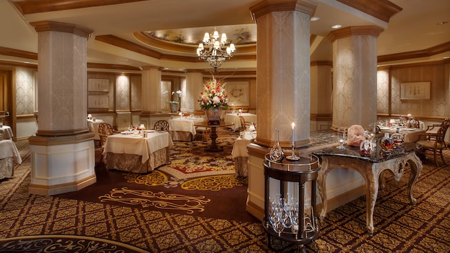 Octagonal dining room with columns, a rotunda ceiling and ornate carpeting