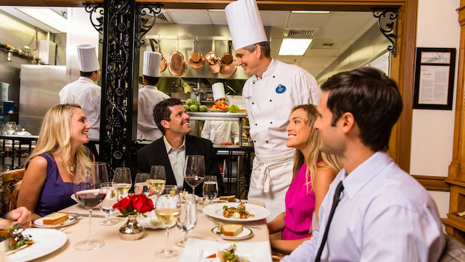 A Chef greets a table of Guests dining at Victoria and Albert's restaurant