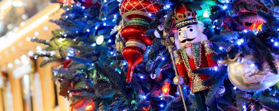 illuminated christmas lights assorted glass bulbs and a nutcracker ornament adorn a tree - When Does Disneyland Decorate For Christmas 2017 illuminated christmas lights assorted glass bulbs and a nutcracker ornament adorn a tree - When Does Disneyland Decorate For Christmas 2017